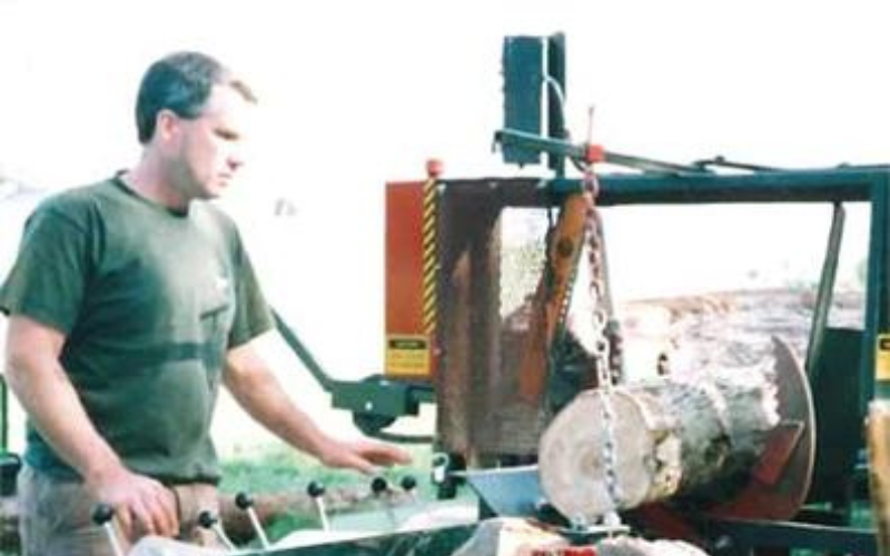 A younger Paul Osborne processes cordwood at the Osborne Farm